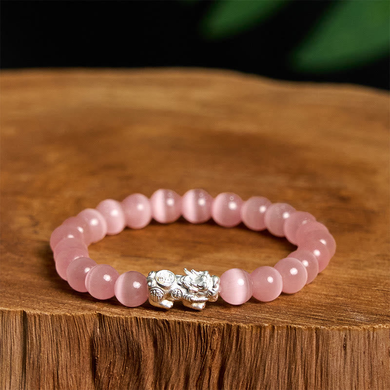Cat's Eye 990 Sterling Silver Pixiu Positive Energy Bracelet – pink cat's eye beads with silver Pixiu charm on wooden stump, love energy bracelet