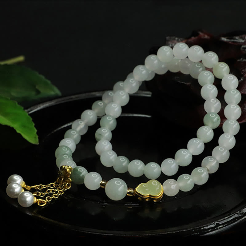 Tianshan Jade Lotus Gourd Bracelet – Heart-shaped jade pendant in gold bezel with pearl dangle, jade bracelet