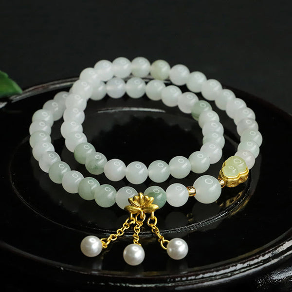 Tianshan Jade Lotus Gourd Bracelet – Coiled on black dish with gold lotus charm and pearl tassels, jade bracelet