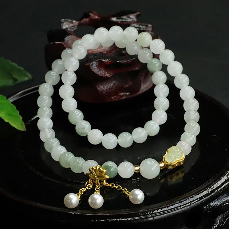 Tianshan Jade Lotus Gourd Bracelet – Pale beads with gold heart charm beside carved wood, jade bracelet
