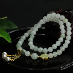 Tianshan Jade Lotus Gourd Bracelet – Heart-shaped jade pendant in gold bezel with pearl dangle, jade bracelet