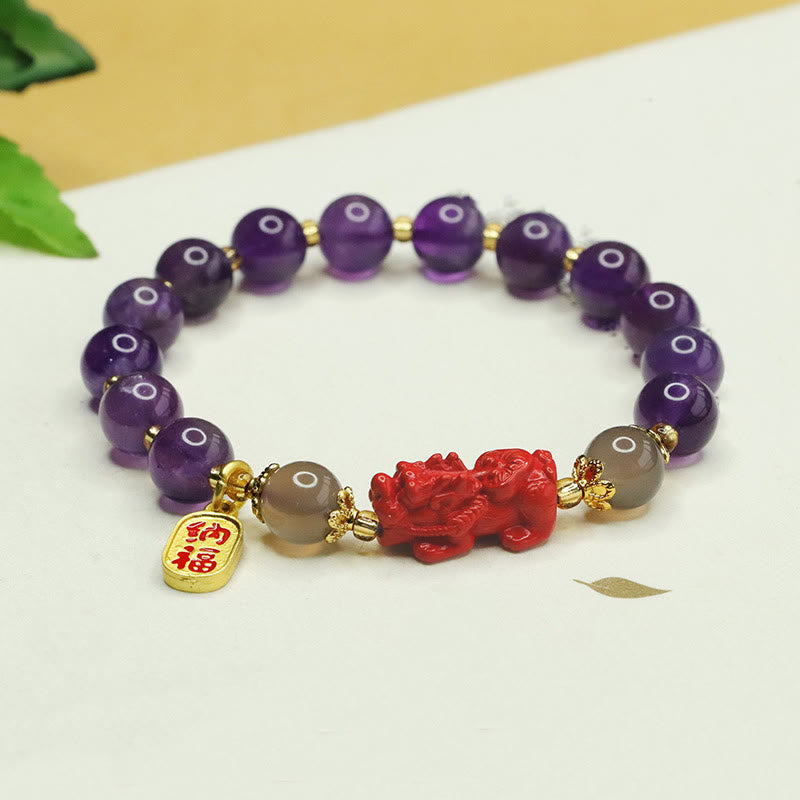 Amethyst Cinnabar Pi Xiu Fu Character Balance Bracelet – purple amethyst beads with red cinnabar Pixiu and gold Fu charm on white background, feng shui wealth bracelet