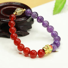 Natural Amethyst Red Agate PiXiu Balance Bracelet – curved dark wood stand, green leaf, balance healing crystal jewelry gift