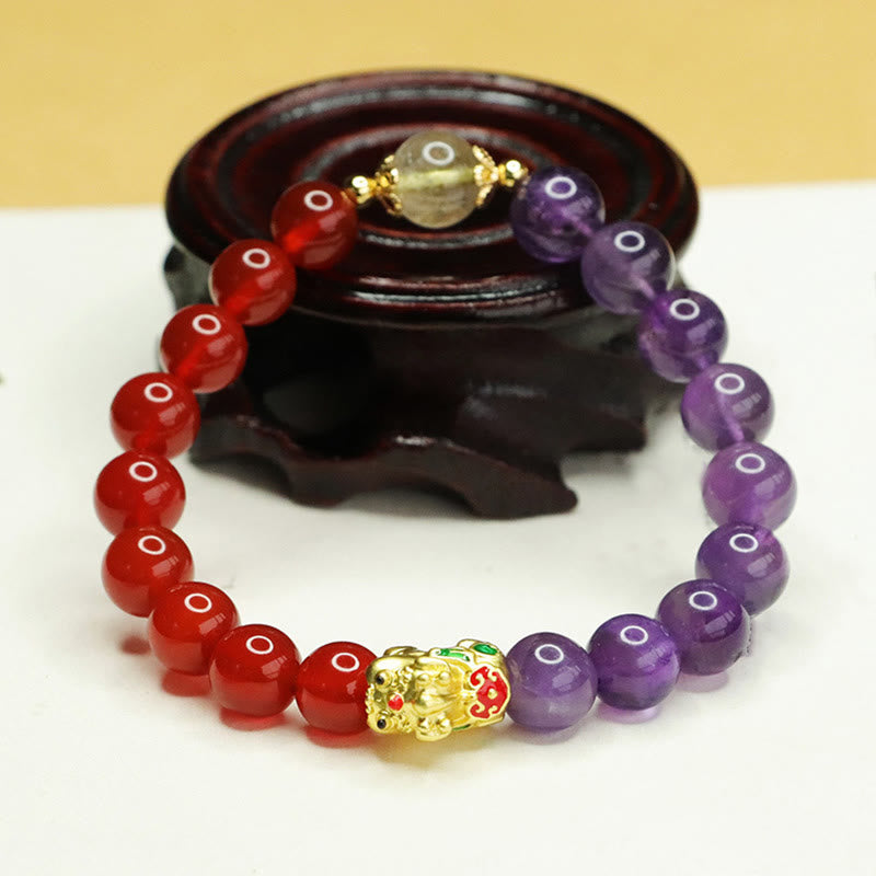 Natural Amethyst Red Agate PiXiu Balance Bracelet – on dark wooden display stand, gold enamel PiXiu, feng shui balance gift