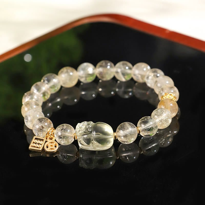 Natural Citrine PiXiu Copper Coin Wealth Bracelet – on black reflective surface, warm lighting glow, crystal wealth bracelet