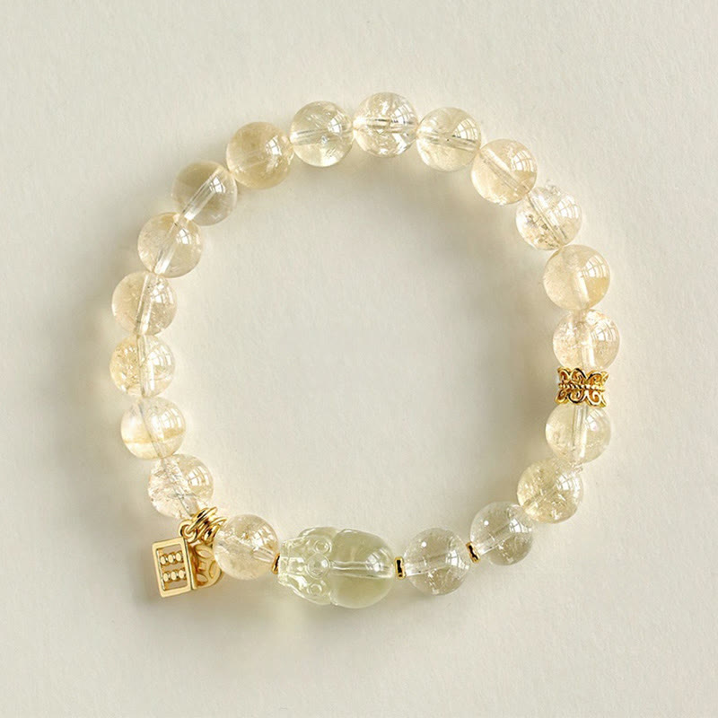 Natural Citrine PiXiu Copper Coin Wealth Bracelet – top-down full circle cream background, gold spacer beads, feng shui gift