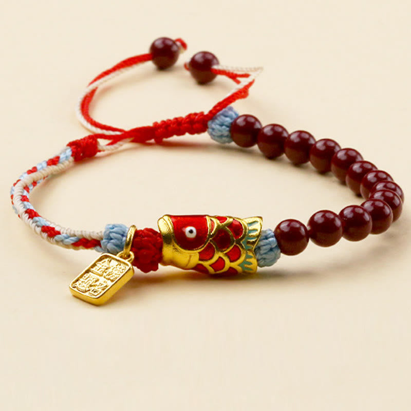 Cinnabar Koi Fish Blessing Bracelet – burgundy beads, gold koi charm, success pendant, tri-color cord, cream background