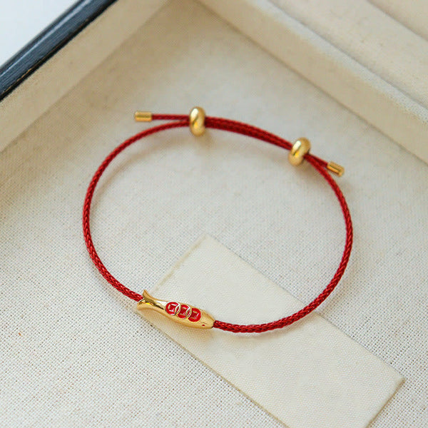 Brass Koi Fish Red String Bracelet – on cream linen near jewelry box, gold fish pendant, braided red lucky cord bracelet