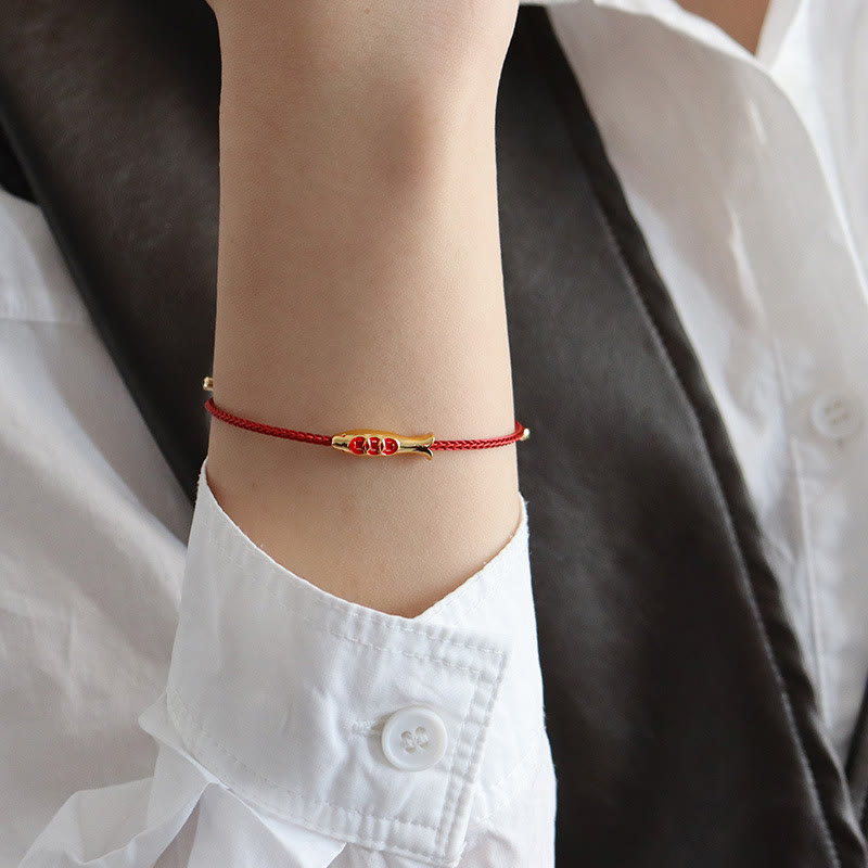 Brass Koi Fish Red String Bracelet – worn on wrist with white shirt, gold koi charm, red string luck bracelet lifestyle shot