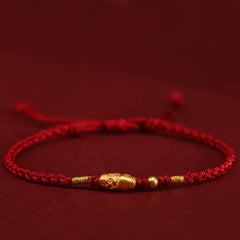 999 Gold Koi Fish Red String Bracelet – barrel gold koi charm with floral motif, gold beads, side angle