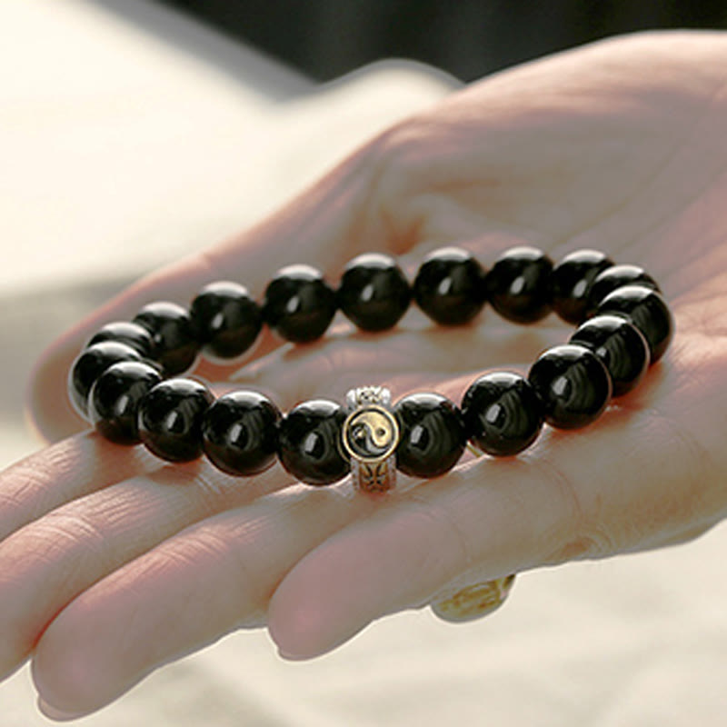 Black Obsidian Nine-Character Mantra Yin Yang Bracelet - on palm gold yin-yang charm, natural stone jewelry