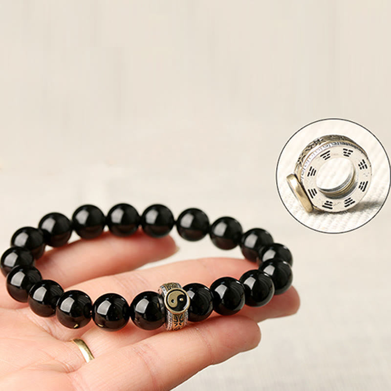 Black Obsidian Nine-Character Mantra Yin Yang Bracelet - hand model with Bagua charm inset, spiritual jewelry