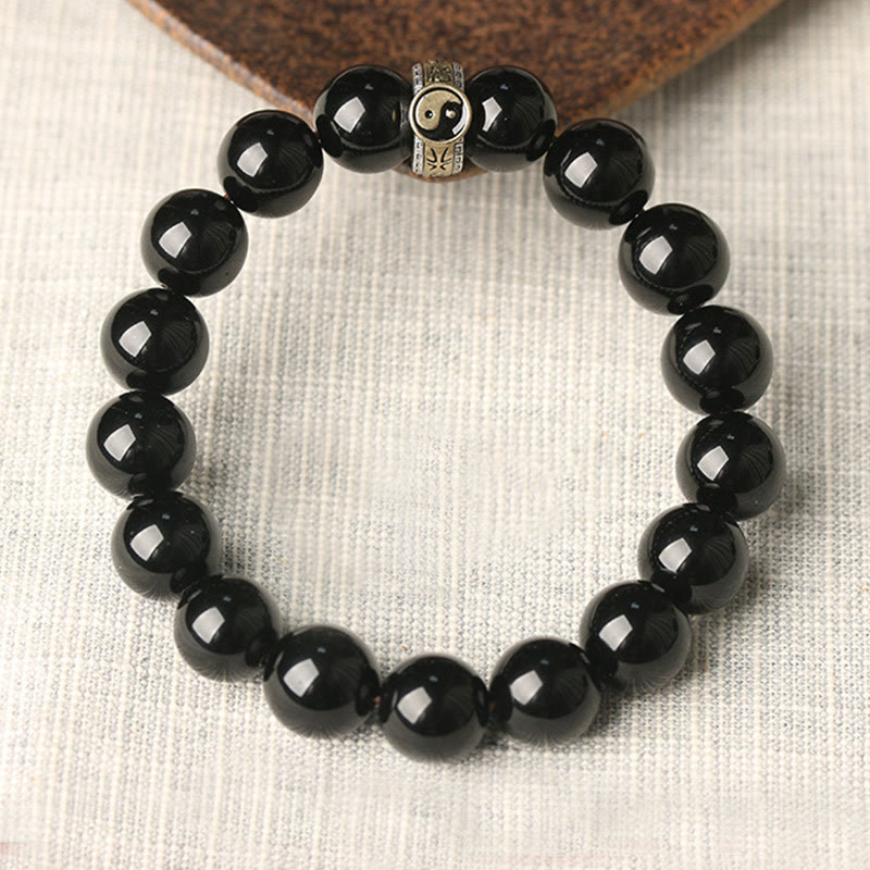 Black Obsidian Nine-Character Mantra Yin Yang Bracelet - overhead silver yin-yang charm, obsidian bead bracelet