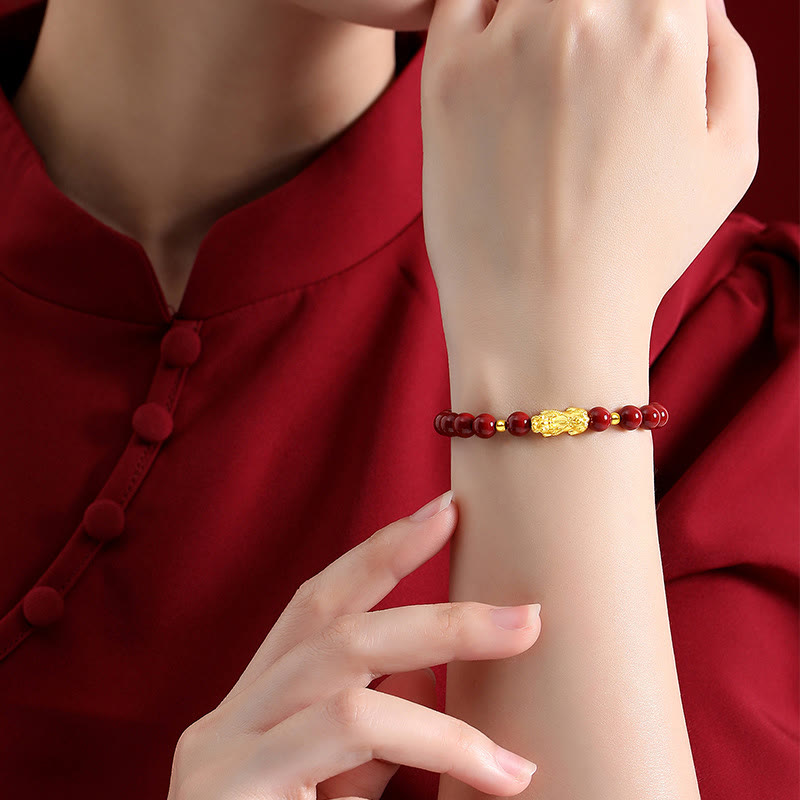 999 Gold Cinnabar PiXiu bracelet – model wearing with red traditional clothing, elegant wealth charm