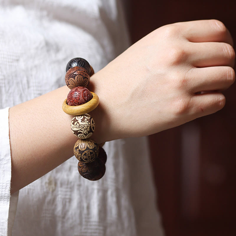 Sandalwood Dragon Phoenix Zodiac Bracelet – worn on wrist white sleeve bokeh, Warmth