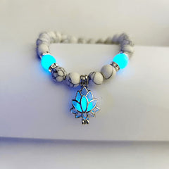 Tibetan Turquoise Glowstone Lotus Bracelet – white howlite beads with cyan glowing lotus pendant on wrist, glowstone bracelet