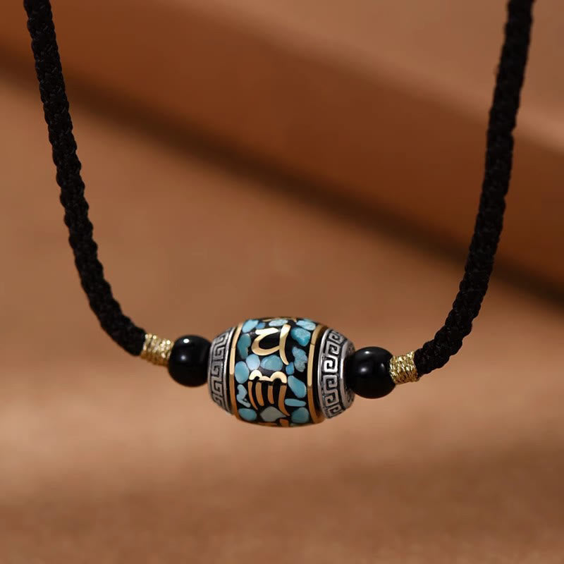 Dzi Bead Om Mani Padme Hum Rotatable Pendant – Frontal view of turquoise inlay barrel bead on black cord, tibetan pendant