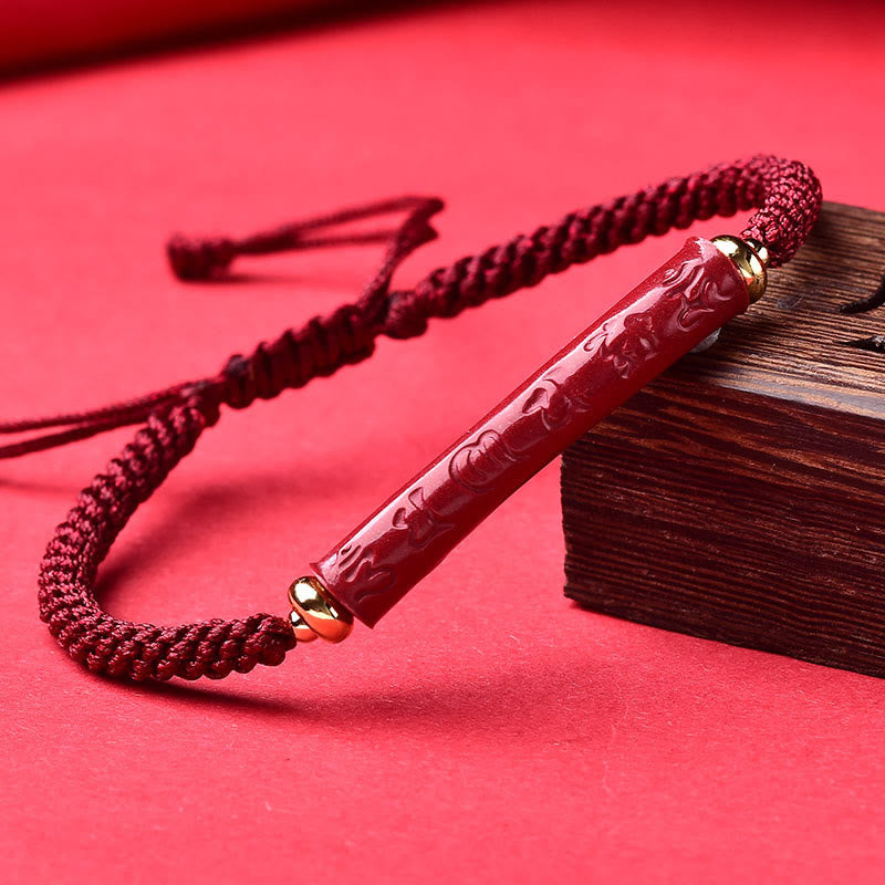 Cinnabar Heart Sutra Blessing Bracelet – carved red bead on burgundy cord with gold caps, cinnabar bracelet