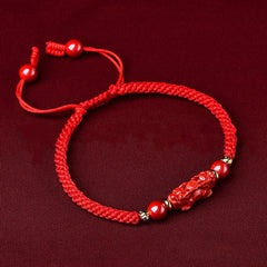 Handcrafted Cinnabar PiXiu bracelet – red braided bracelet side view with adjustable knots, good luck