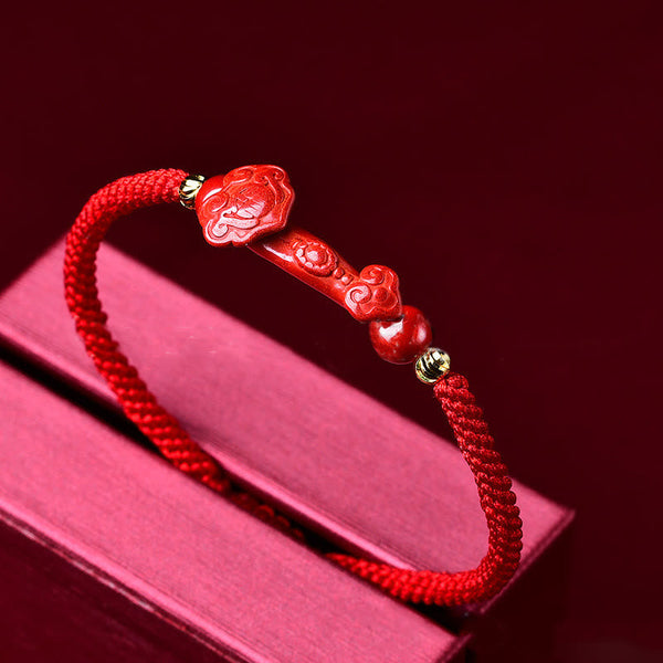 Handcrafted Cinnabar Ruyi bracelet – red braided bracelet with Ruyi stick on red book display, feng shui
