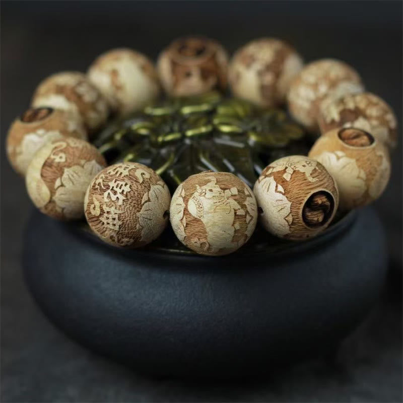 Camphor Wood Yin Yang Ox Engraved Bracelet - Buddha lotus carved beads low-angle, wooden prayer beads