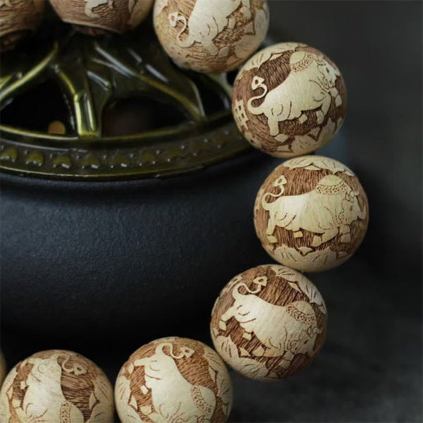Camphor Wood Yin Yang Ox Engraved Bracelet - elephant motif beads close-up detail, carved wood beads