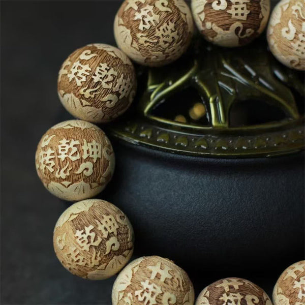 Camphor Wood Yin Yang Ox Engraved Bracelet - carved character beads diagonal close-up, engraved wood