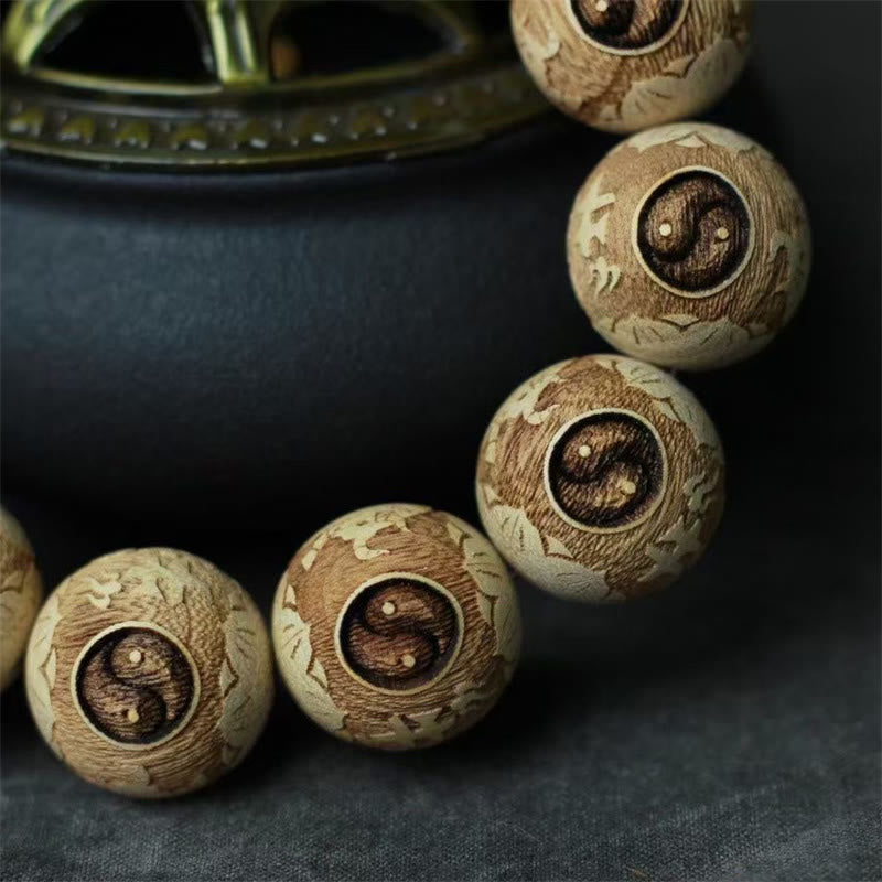 Camphor Wood Yin Yang Ox Engraved Bracelet - yin-yang lotus carved beads close-up, wooden mala beads