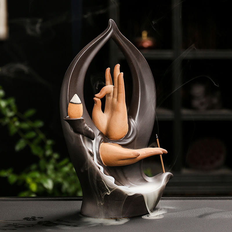 Mountain Water Buddha Hand Incense Burner – Terracotta hands in charcoal frame, smoke pooling