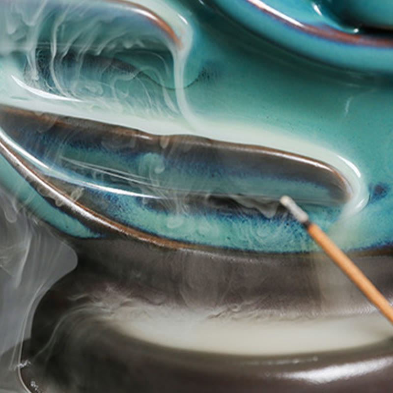 Crescent Moon Incense Burner – Macro view of smoke waterfall flowing through teal ceramic tiers, backflow