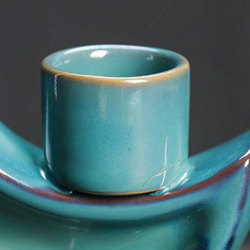 Crescent Moon Incense Burner – Cylindrical candle cup with golden rim on curved teal base, ceramic detail