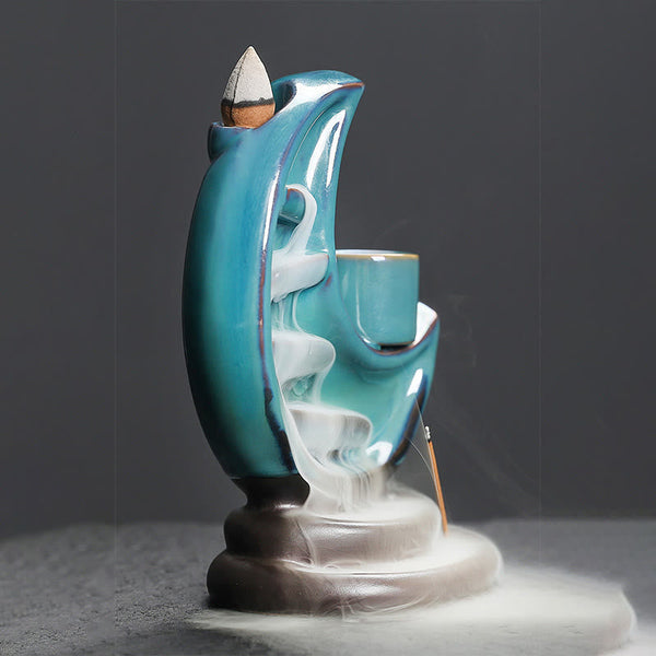 Crescent Moon Incense Burner – White smoke cascading down stepped teal channels with stick incense, calm