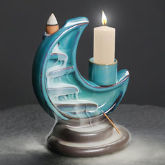 Crescent Moon Incense Burner – Lit candle and cascading smoke on teal crescent moon, meditation calm