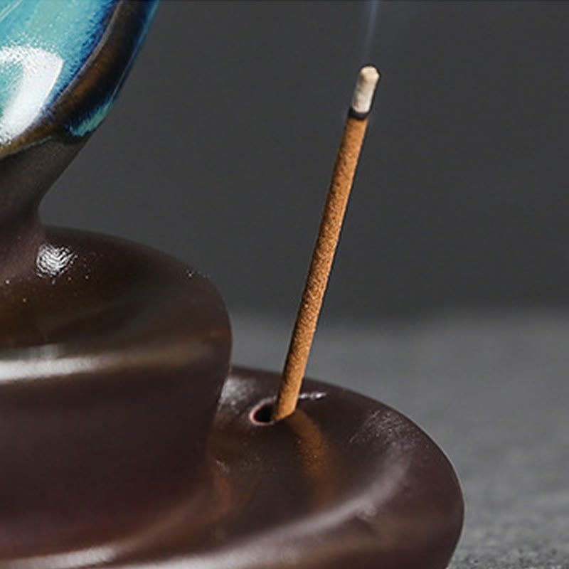 Crescent Moon Incense Burner – Lit incense stick in brown ceramic base holder with teal accent, zen decor