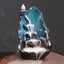Ceramic Backflow Incense Burner – Smoke cascading down teal lotus tiers with stick incense, backflow incense