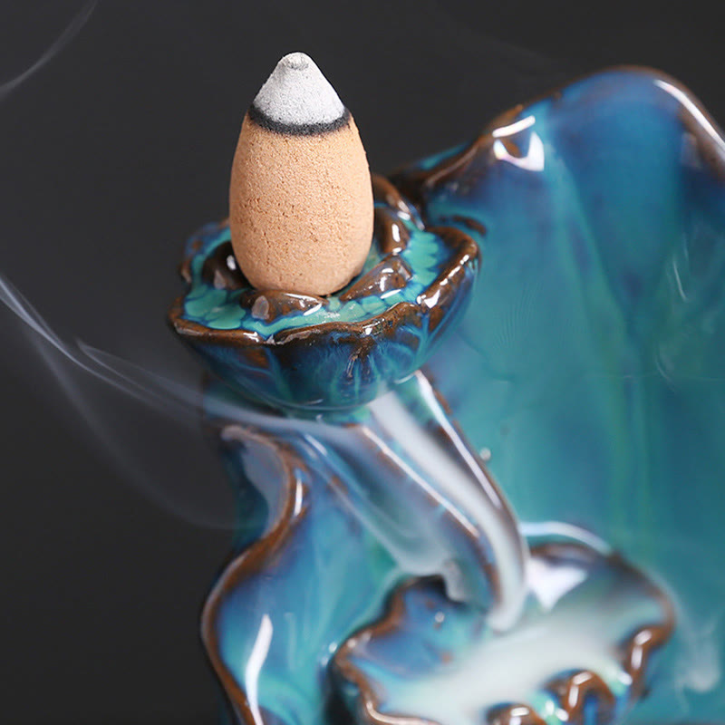 Ceramic Backflow Incense Burner – Macro close-up of burning cone and flowing smoke on glossy glaze, backflow incense