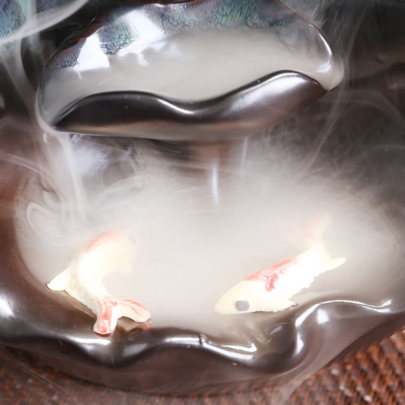 Ceramic Backflow Incense Burner – Koi fish in smoke-filled pool at base of teal waterfall, backflow incense