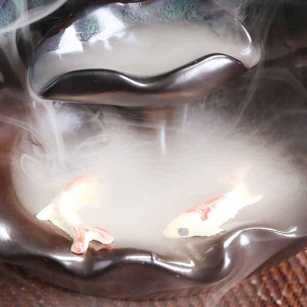 Ceramic Backflow Incense Burner – Koi fish in smoke-filled pool at base of teal waterfall, backflow incense