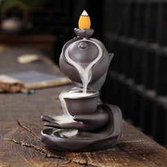 Buddha Hand Teapot Incense Burner – Teapot pours smoke into cup, stacked on open palm, backflow effect