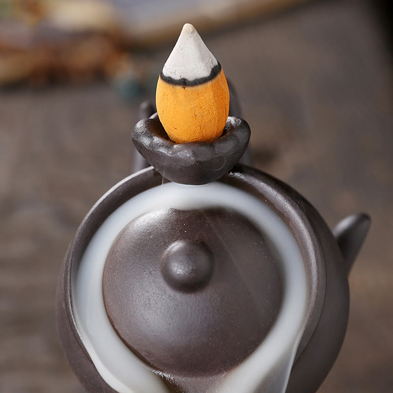 Buddha Hand Teapot Incense Burner – Close-up of teapot lid with lit cone, smoke begins backflow cascade