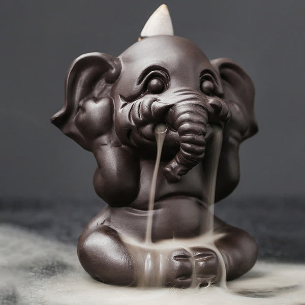 Cute Elephant Incense Burner – Close-up of lit incense cone in holder, burned ash tip, ceramic