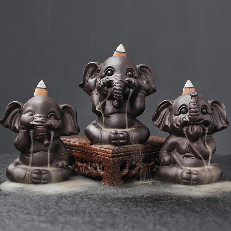 Cute Elephant Incense Burner – Three wise elephants smoke cascade, wooden stand, gray backdrop