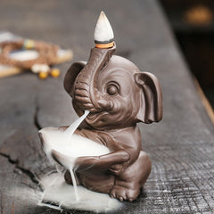 Elephant Backflow Incense Burner - Elevated angle showing smoke waterfall effect, purple clay censer