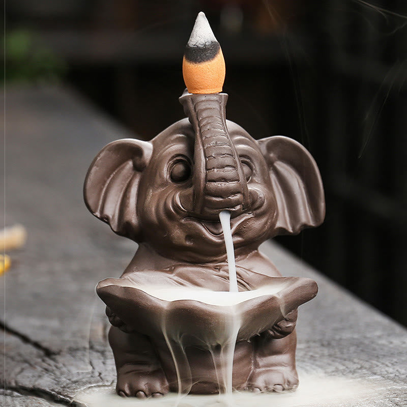 Elephant Backflow Incense Burner - Front-facing with smoke waterfall on dark stone, purple clay censer