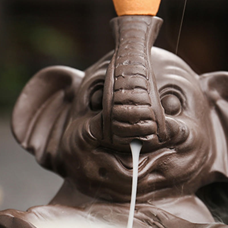 Elephant Backflow Incense Burner - Close-up face with trunk detail and smoke stream, purple clay censer