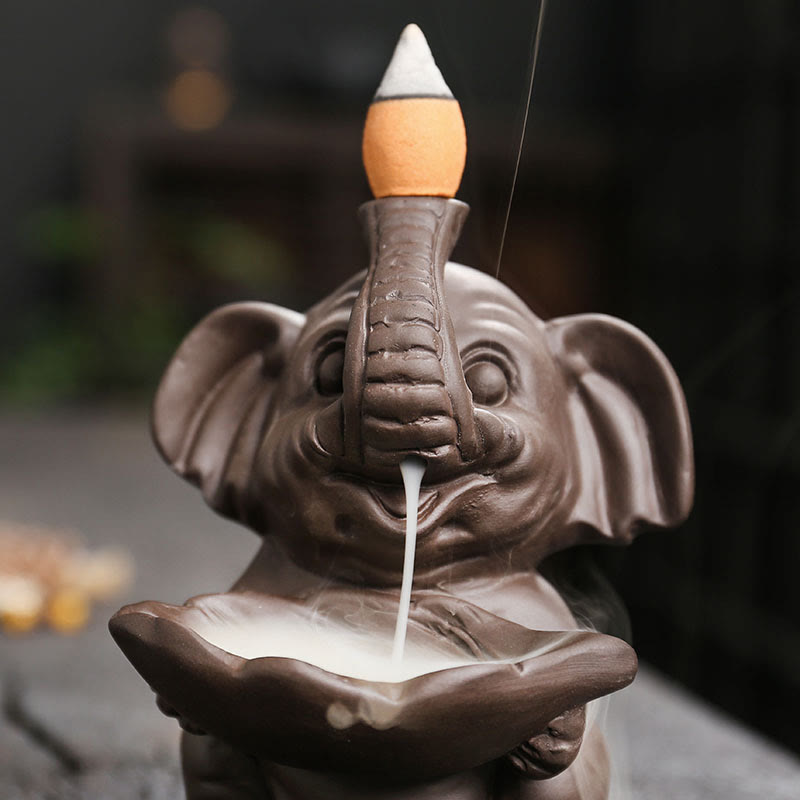 Elephant Backflow Incense Burner - Close-up of smoke flowing from trunk to lotus bowl, purple clay censer