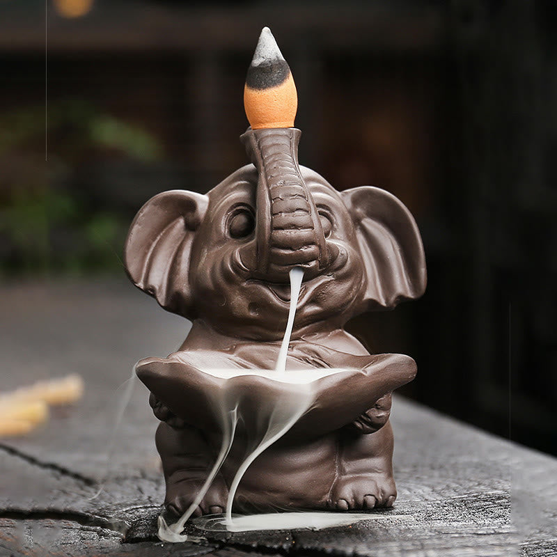 Elephant Backflow Incense Burner - Low angle frontal view with dramatic smoke cascade, purple clay censer