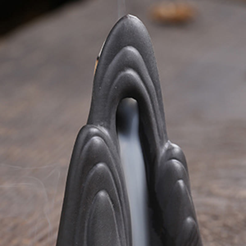 Little Monk Purple Clay Backflow Incense Burner - Layered mountain with central smoke channel on wood, zen waterfall