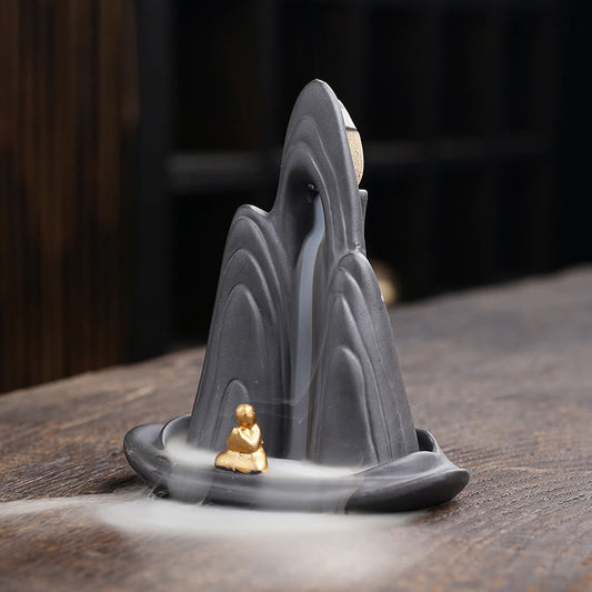 Little Monk Purple Clay Backflow Incense Burner - Charcoal peaks with flowing smoke and gold meditator, waterfall burner