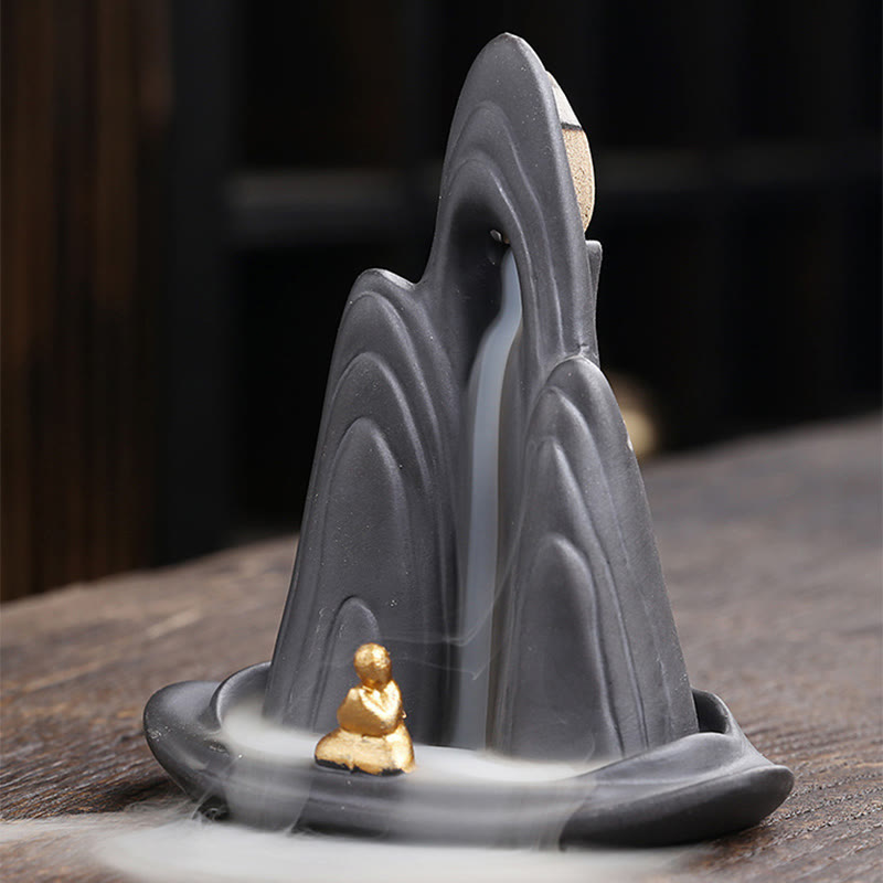 Little Monk Purple Clay Backflow Incense Burner - Tiered gray peaks with gold meditator and flowing smoke, backflow